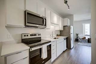 a kitchen with stainless steel appliances and white cabinets