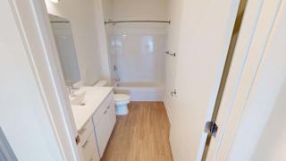 a white bathroom with a toilet and a sink