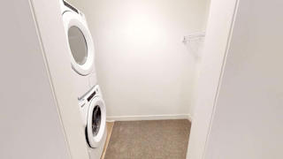 a washer and dryer in a white laundry room