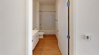 a bathroom with a toilet and a sink and a shower