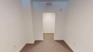 a empty room with a door to a closet