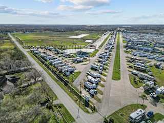 A bird's eye view of a residential area with houses and cars.