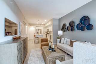 A modern living room with a white sofa and a wooden coffee table.