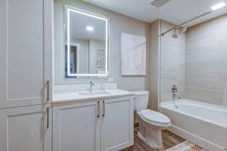 A white bathroom with a toilet, sink, and bathtub.