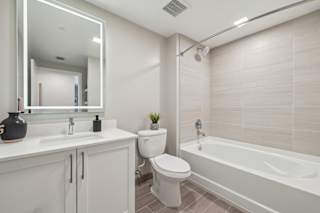 A white bathroom with a toilet, sink, and bathtub.