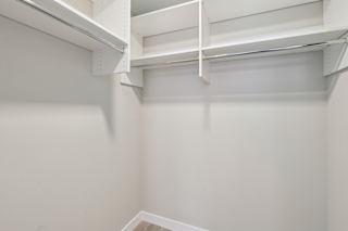 A white empty room with a shelf on the wall.