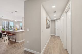 A long hallway with a white door at the end.