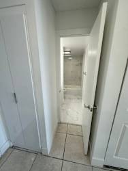A white door is open to a bathroom.