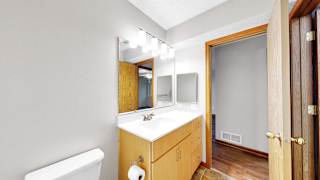 A bathroom with a white sink and a white toilet.
