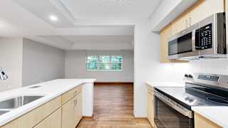A kitchen with a stove, oven, and microwave.