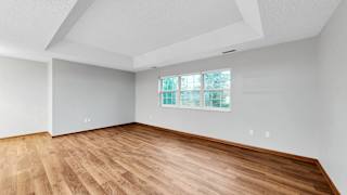 A room with wooden flooring and a window.