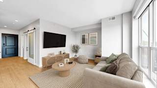 A modern living room with a grey sofa and a wooden coffee table.