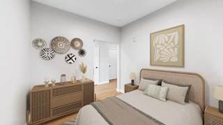 A bedroom with a bed, nightstand, and a wall art.