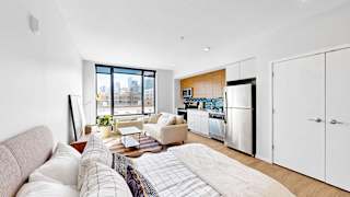 A modern living room with a large window overlooking the city.