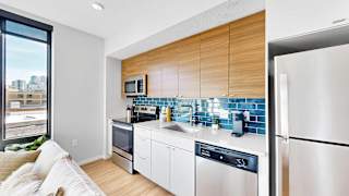 A modern kitchen with a refrigerator on the right.