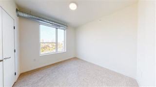 A room with a window and a door at The Bessemer at Seward Commons Apartments, Minneapolis, 55404