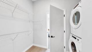 A white laundry room with a washer and dryer.