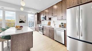 A modern kitchen with a large island and stainless steel appliances.
