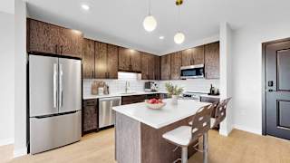 A modern kitchen with a wooden backsplash and stainless steel appliances.