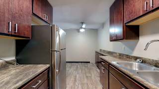 a kitchen with wood cabinets and stainless steel appliances