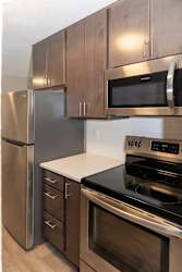 a kitchen with stainless steel appliances and wooden cabinets