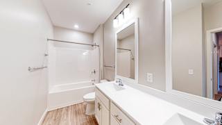 a bathroom with a bathtub and a toilet at The Morrison, Rosemount
