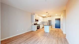 a kitchen and living room with hardwood floors at The Morrison, Rosemount, 55068
