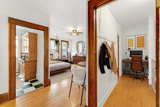 a living room with a mirror and a bedroom with a bed at The Park Apartments, Minneapolis, MN, 55403