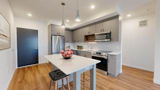 A modern kitchen with a dining table and chairs.at Tyler Street Stacks, Minneapolis, MN