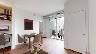 a dining room with a table and chairs and a sliding glass door to a balcony at Tyler Street Stacks, Minnesota