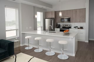 Joel 1 bedroom kitchen with seating at bar area at Urban Park I and II Apartments, St Louis Park, MN