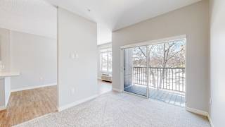 a bedroom with a sliding glass door leading to a balcony