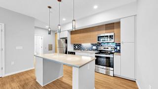 A modern kitchen with a large island in the middle.