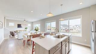 A modern kitchen with a dining table and chairs.
