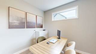 A room with a desk, chair, and three pictures on the wall.