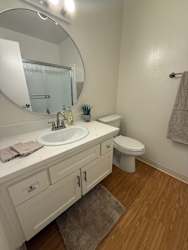 A bathroom with a white sink and toilet.