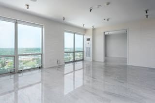 A spacious room with a view of the cityscape outside the large windows at Clayton on the Park Apartments, Clayton