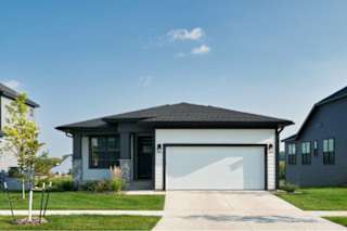 a large house with a driveway and a garage door