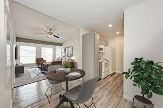 A modern kitchen with a dining table and chairs.