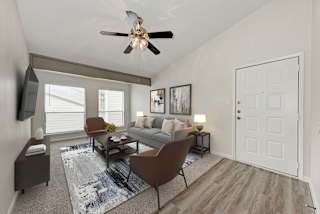 A living room with a brown chair and a grey couch.