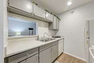 A kitchen with a sink and a window.
