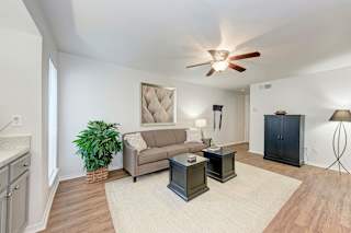A living room with a ceiling fan and a couch.