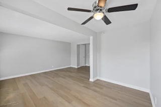 A room with a ceiling fan and light fixture, and a wooden floor at Huntley Ridge Apartments, Kettering, Ohio
