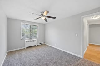 A room with a ceiling fan and a window with blinds at Huntley Ridge Apartments, Ohio