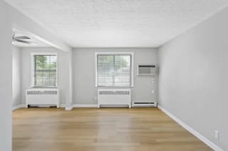 A room with two windows and a radiator on the wall at Huntley Ridge Apartments, Kettering, OH