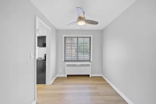 A room with a ceiling fan and a window with blinds at Huntley Ridge Apartments, Kettering