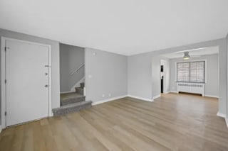 A room with wooden flooring and white walls at Huntley Ridge Apartments, Kettering, Ohio
