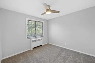 A room with a ceiling fan and a window with blinds. at Huntley Ridge Apartments, Kettering, OH, 45419