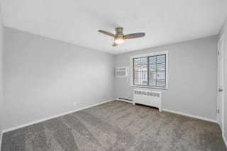 A room with a ceiling fan and a window with blinds at Huntley Ridge Apartments, Kettering 45419