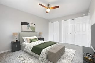 A bedroom with a bed, nightstands, and a ceiling fan at Parkview of Lebanon Apartments, Indiana, 46052